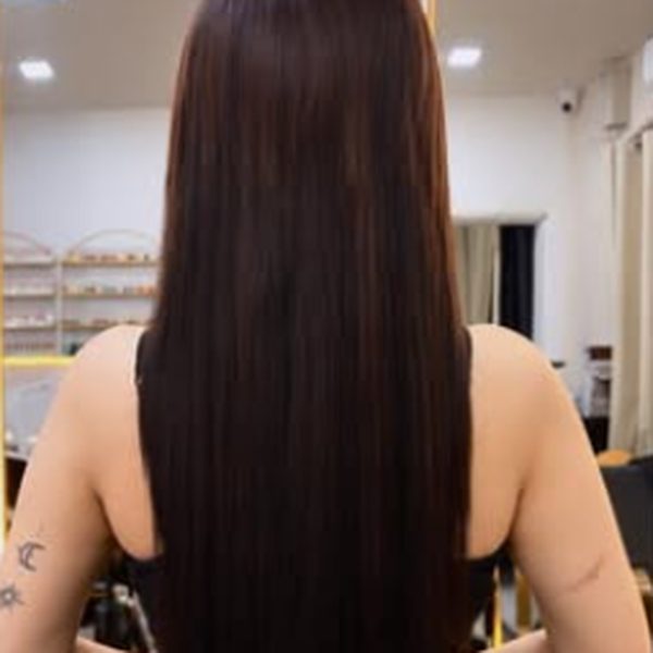 Long, straight dark hair after a mermaid hair extension, seen from behind in the lounge