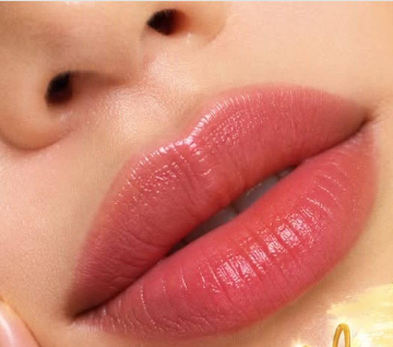 Close-up of softly tinted coral-pink lips
